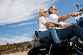 Couple Riding a Motorcylce with Motorcycle Insurance in Houston, Pasadena, League City, Texas Gulf Coast